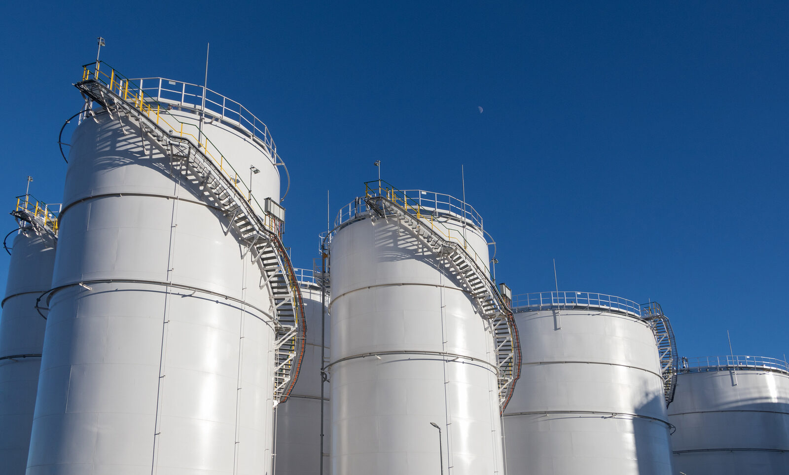 Fuel tanks at the tank farm. Big Industrial oil tanks in petroleum storage terminal